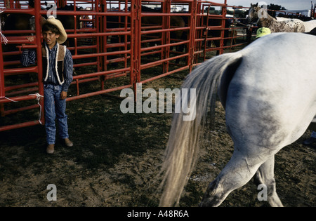 lincoln highway child cowboy standing by horse pen at rodeo bellvue iowa 1993 Stock Photo