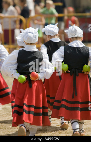 Basque girls performing Basque folk dance holding apples in hands behind backs fiesta Andra Mari de Gorliz Basque Country Stock Photo