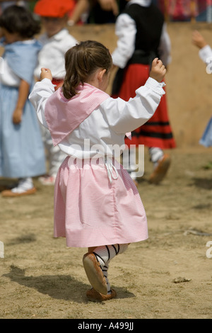 Very young Basque girl in pink dress performing traditional folk dance fiesta Andra Mari de Gorliz Basque Country Spain Stock Photo