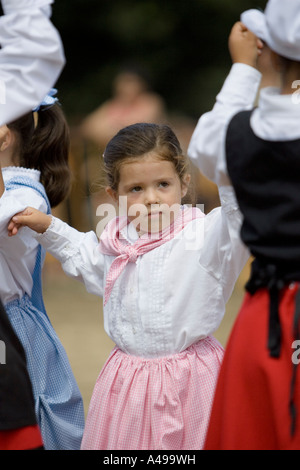 Very young Basque girl performing traditional Basque folk dance fiesta Andra Mari de Gorliz Basque Country Spain Stock Photo