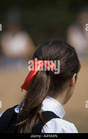 Red ribbon in hair of Basque teenage girl performing traditional folk dance fiesta Andra Mari de Gorliz Basque Country Stock Photo