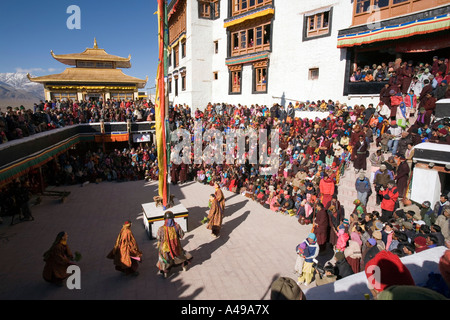 India Ladakh Leh Valley Spitok Gompa festival pilgrims watching dance in monastery courtyard Stock Photo