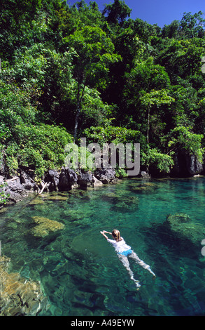 Lone traveller swimming in Kayanga lake, the cleanest lake in the Philippines, Coron Island Palawan Philippines Southeast Asia Stock Photo