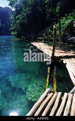 Lone traveller swimming in Kayanga lake, the cleanest lake in the Philippines, Coron Island Palawan Philippines Southeast Asia Stock Photo