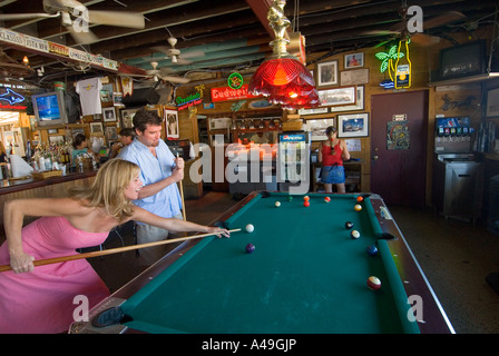 USA Florida Keys Couple playing pool in the Hog Fish Bar & Grill Stock Island Key West Stock Photo