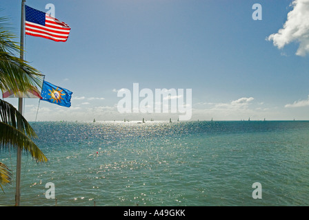 USA Florida Keys Key West View of flags flying and sailboats in the distance Southernmost Beach Hotel Stock Photo