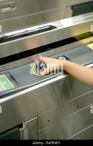 Close-up of human hand inserting coin in vending machine Stock Photo ...