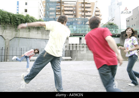 Two young women and two young men playing Stock Photo