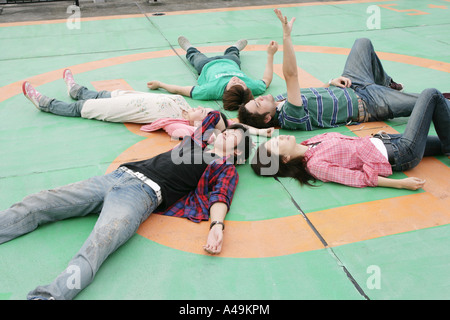 High angle view of two young women and three young men lying on the floor Stock Photo
