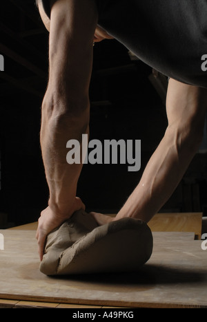 Side profile of a potter kneading clay Stock Photo