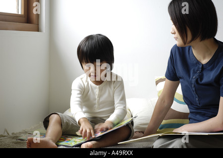 Mid adult woman teaching her daughter Stock Photo