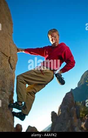 Man gets chaulk from bag while bouldering in Boulder Colorado Stock Photo