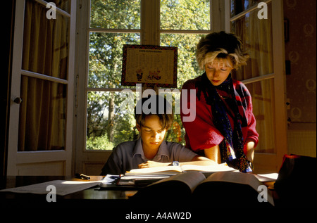 A boy goes through his French work with his teacher.Cothill School is a fee-paying private prep school based in Oxfordshire Stock Photo