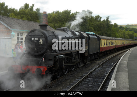 Steam engine train going through the Yorkshire Moors, departing from Grosmont Stock Photo