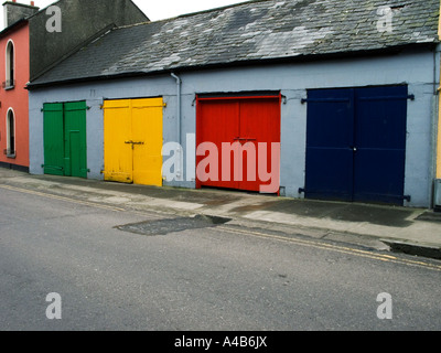 row of multicoloured wooden garage doors in Clonakilty Eire Stock Photo