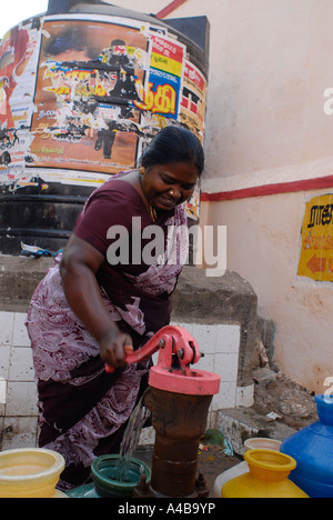 Stock Image of Dalit Women at communal community well in Jagathapuram slum in Chennai Tamil Nadu India Stock Photo