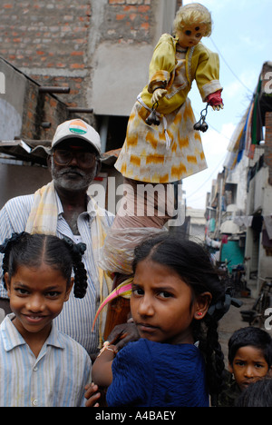 Stock image of children and puppet master in an Indian slum Stock Photo