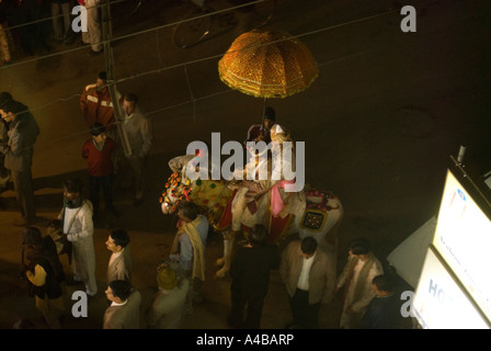 Stock image of night time Hindu wedding procession through the streets of Varanasi with musicians and wild dancers in suits Stock Photo