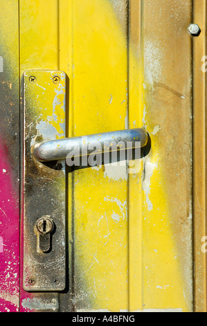 Door handle defaced by spray-painted graffiti (graffito) - detail Stock Photo