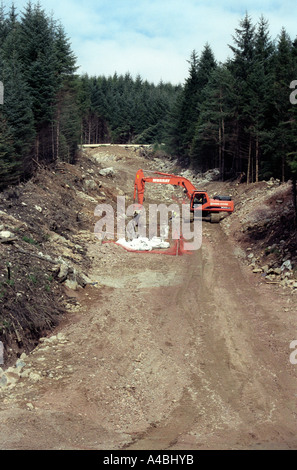 construction of new pipe line through forest Scotland Scottish UK, Blue Sky Stock Photo