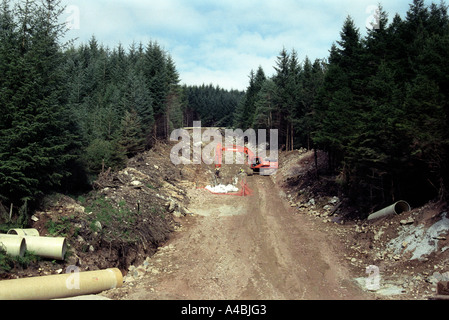 construction of new pipe line through forest Scotland Scottish UK, Blue Sky Stock Photo