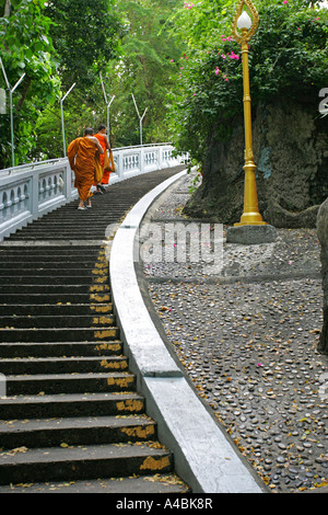 Buddhist monk ascending staircase step by step at Wat Saket aka The Golden Mount Bangkok Thailand Stock Photo