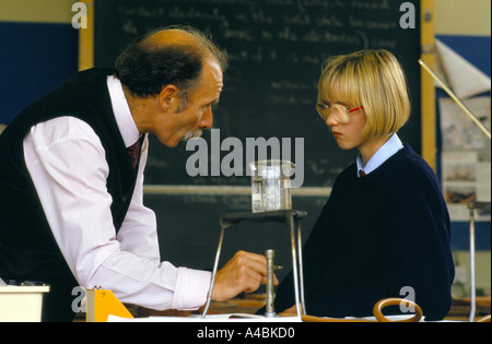Holyrood Secondary School, Glasgow. A science teacher in discussion with a girl student in the science lab. Stock Photo
