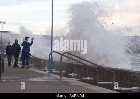 Waves break over Eyemouth beach wall North Sea fishing port Scottish Borders UK Stock Photo