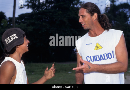Paraty, Rio de Janeiro, Brazil. Man and woman (with police hat) in white t-shirts, his says 'Cuidado!' (be careful). Stock Photo