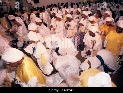 Members of the Celestial Church Of Christ  pray during the harvest festival celebration and worship at their church in London Stock Photo