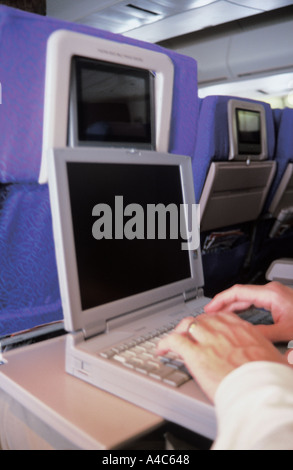 Using laptop in-flight Stock Photo