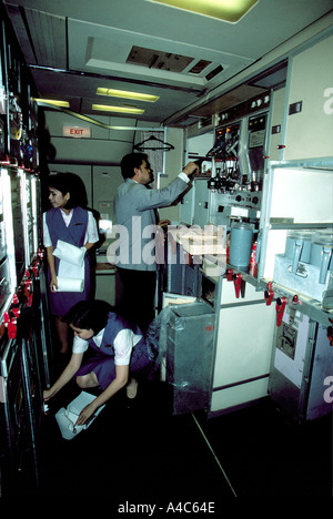 Cabin crew working in galley Stock Photo