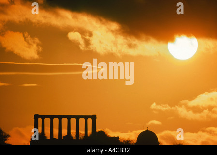 Mock-classical columns seen against dramatic sunset sky Calton Hill Edinburgh Scotland UK Stock Photo