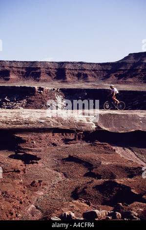 Cyclist on Mussleman Arch on White Rim Trail Canyonlands Utah USA Stock Photo