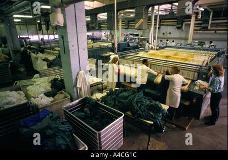 Laundry staff at work in the hospital laundry at Whipps Cross Hospital, London Stock Photo