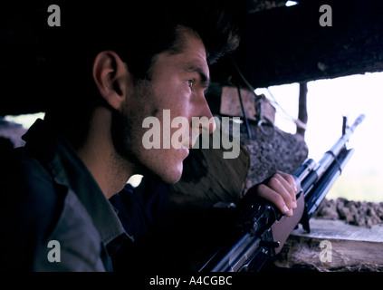 A Bosnian Serb soldier with his AK 47 rifle on the front line against Muslim forces near Zvornik,  Sept 1992 Stock Photo
