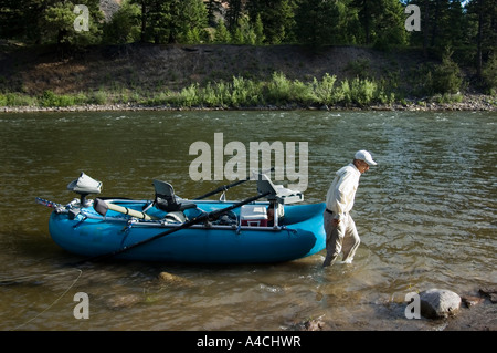 A Montana fly fishing guide with his raft on the Blackfoot River