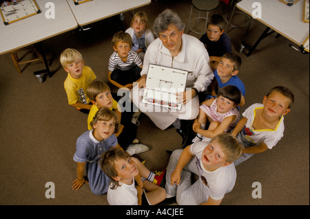 A primary school teacher explaining the priciples of electricity to his class. Stock Photo