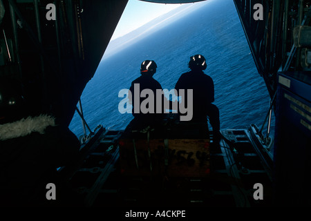 USCG crew of the International Ice Patrol on the loading ramp of the HC130 Hercules prepare to drop weather buoys Stock Photo