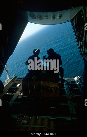 USCG crew of the International Ice Patrol on the loading ramp of the HC130 Hercules prepare to drop weather buoys Stock Photo