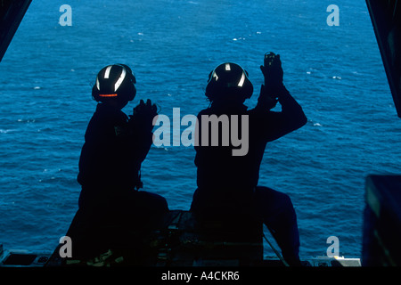 USCG crew of the International Ice Patrol on the loading ramp of the HC130 Hercules prepare to drop weather buoys Stock Photo