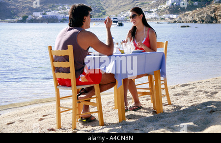 Young couple eating at seaside restaurant Stock Photo