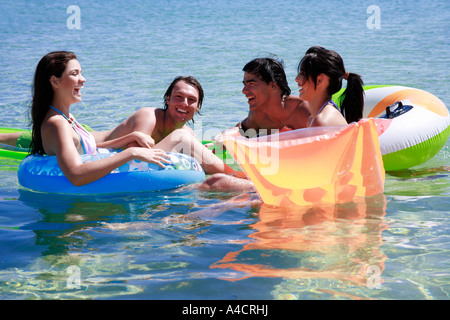 Group of friends playing in the water Stock Photo