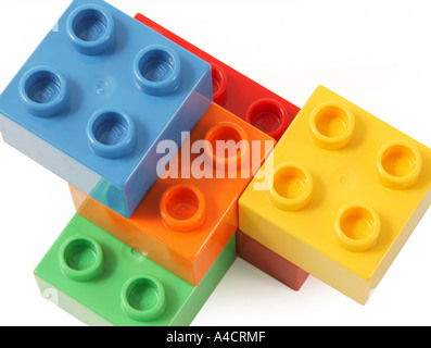 simple construction made from child's lego in studio on clean white surface involving blue orange yellow green and red colors Stock Photo