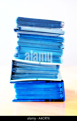 One stack of nine (9) small photo albums containing prints, on table surface. Image with Limited Depth of Field. Stock Photo