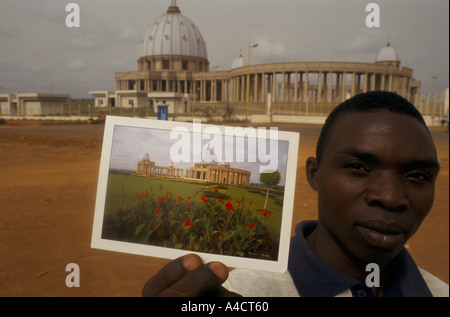 boigny s funeral ivory coast man selling postcards of basilica with basilica in background yamoussoukro feb 1994 Stock Photo