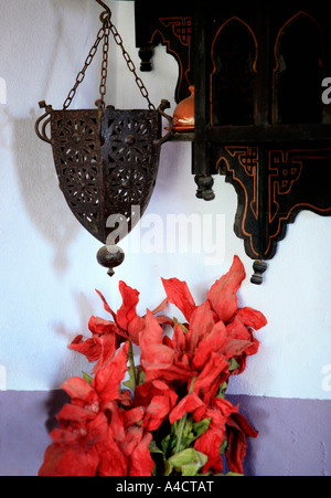 Table with jars flowers and cup of spoons Stock Photo