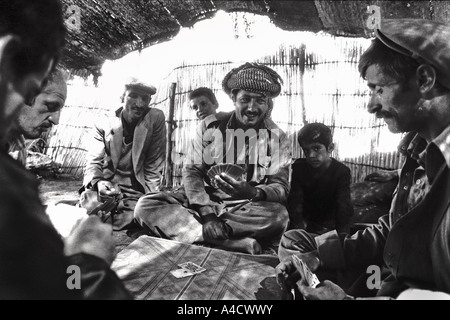 July 1987 Iraq Turkey border Kurdish tribesmen play cards in a traditional goat hair tent Photo by Richard Wayman Stock Photo