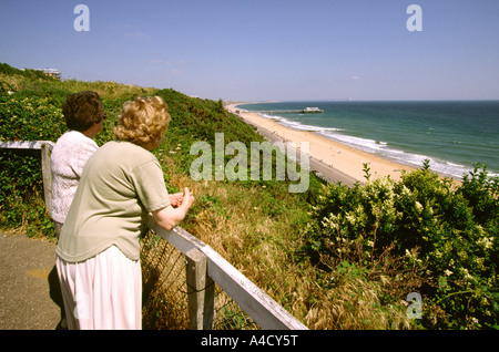 UK Dorset Bournemouth two women on cliff path above the beach at Boscombe