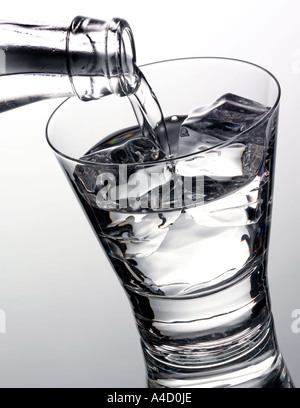 Drink spring water pouring in to bottle over sunlight and natural ...